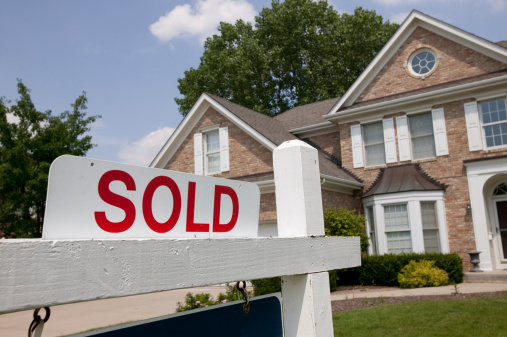 House with "Sold" sign outside